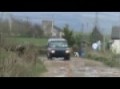 Land Rover Discovery speeding through puddles and taking off getting air borne
